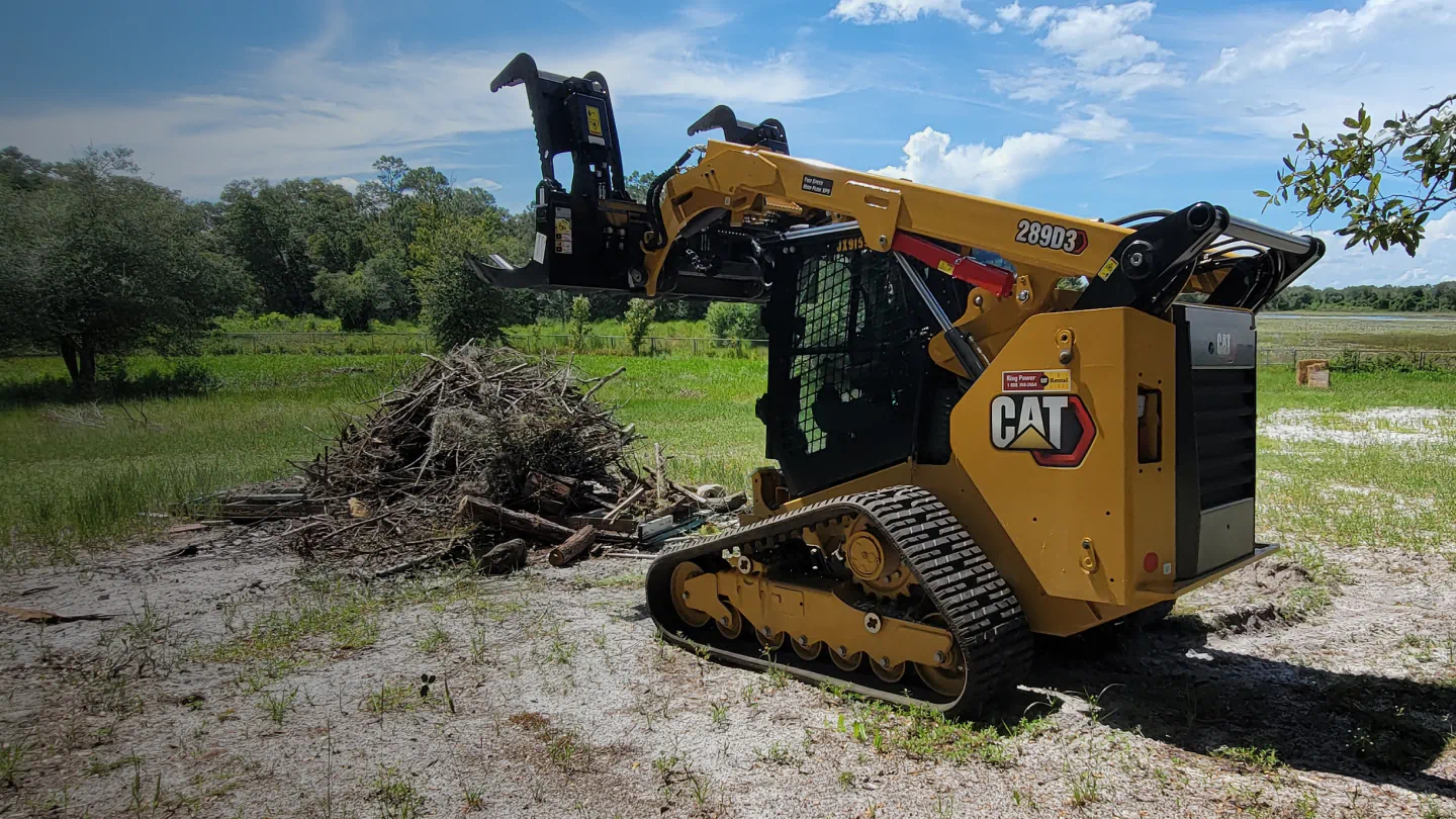 skid steer doing a land clearing